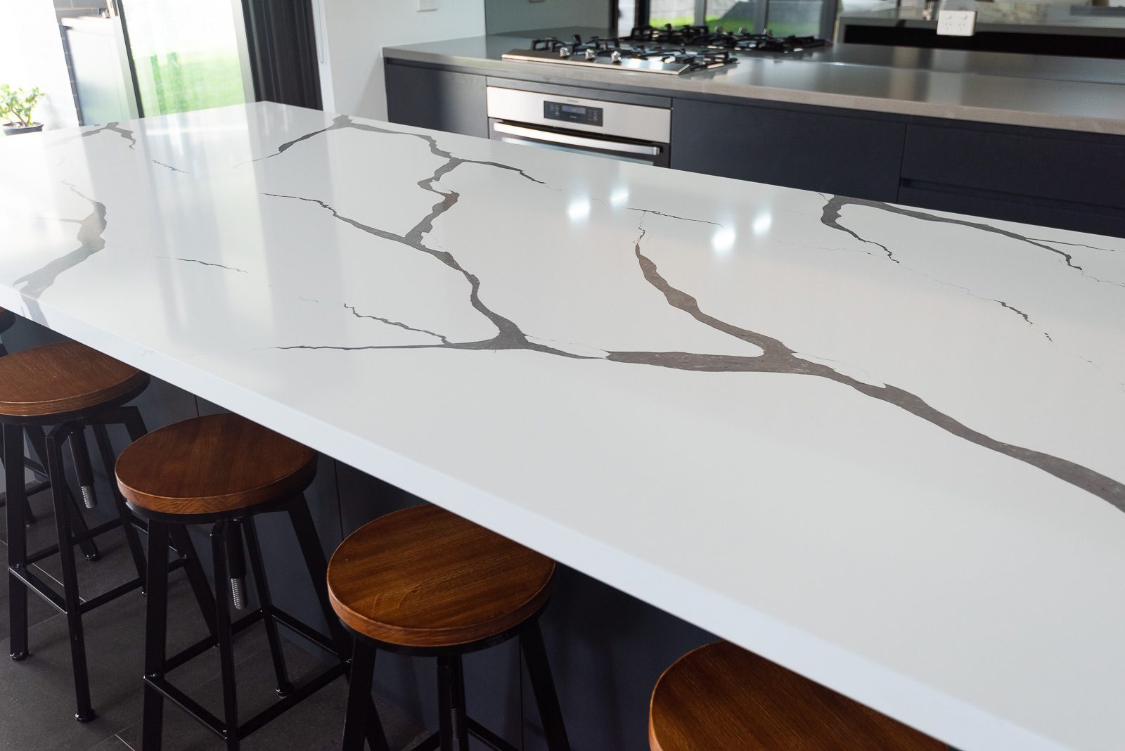 Marble benchtop with timber stools