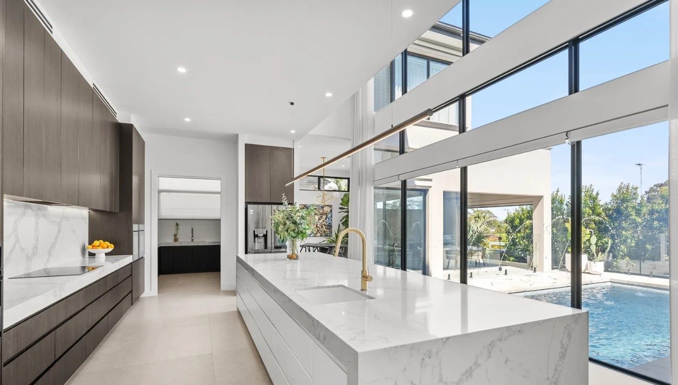 Kitchen island beneath a double-height void